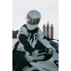 Бяло мото яке ICON Merc3 ANOMALY с черни графични елементи, носено от мотоциклетист с бяла каска седнал на бял мотор