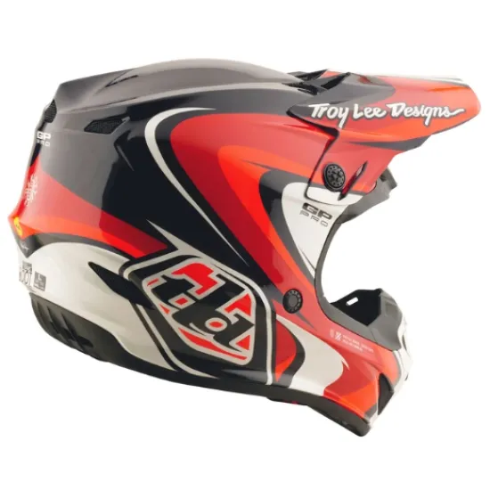 Детска мотокрос каска Troy Lee Designs GP Pro в червено-черна цветова схема с бели акценти, показваща агресивен графичен дизайн и логото на TLD