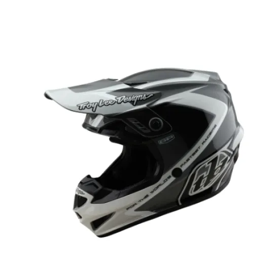 Сиво-бяла мотокрос каска Troy Lee Designs GP Shutter с геометричен дизайн, TLD лого и удължен визьор, показана от профил и отгоре