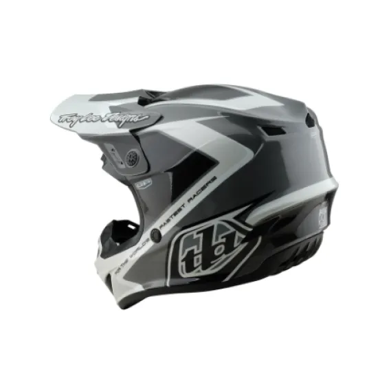 Сиво-бяла мотокрос каска Troy Lee Designs GP Shutter с геометричен дизайн, TLD лого и удължен визьор, показана от профил и отгоре
