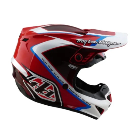 Червено-бяла мотокрос каска Troy Lee Designs GP Shutter с геометричен дизайн, сини акценти, черен визьор и множество вентилационни отвори