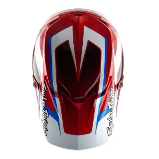 Червено-бяла мотокрос каска Troy Lee Designs GP Shutter с геометричен дизайн, сини акценти, черен визьор и множество вентилационни отвори