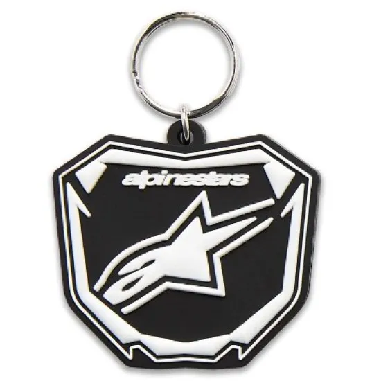 Черно-бял ключодържател Alpinestars със щитовидна форма, централно бяло лого на черен фон и метален ринг
