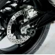 Черни краш тапи R&G Racing монтирани на задната ос на мотоциклет, показани от различни ъгли с видима верига и спирачен диск