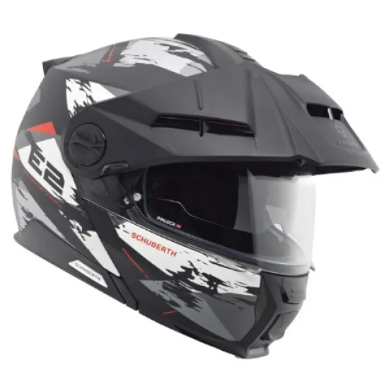 Сива адвенчър каска SCHUBERTH E2 Trail Grey с бяло-червен дизайн, регулируема козирка, двоен подбрадник и вентилационни отвори