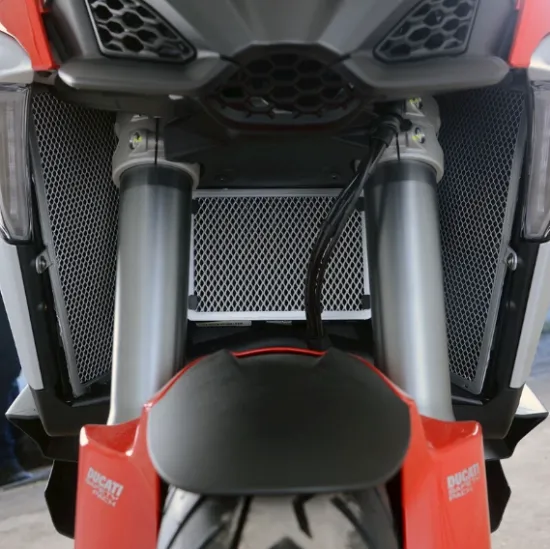 Черен протектор за радиатор R&G Racing с алуминиева диамантена мрежа, монтиран на Ducati Multistrada V4S между сребристите прави вилки, с видимо лого Ducati на червената предна маска