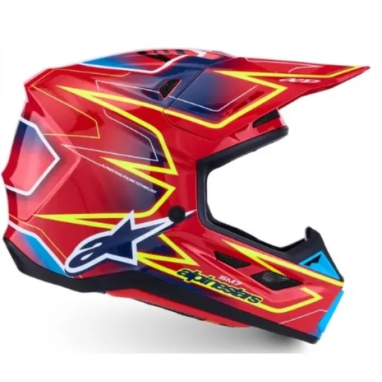 Alpinestars SM7 Cast мотокрос каска в червено с жълти и сини графики, изглед отстрани и отгоре, композитна черупка с